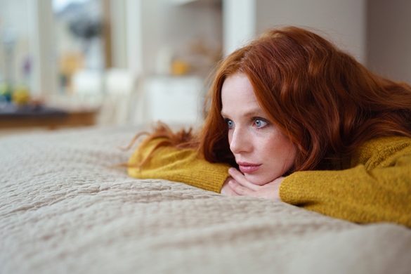 Attractive young redhead woman lying on her bed - Does The Gemini Man Miss His Woman When She Isn’t Around