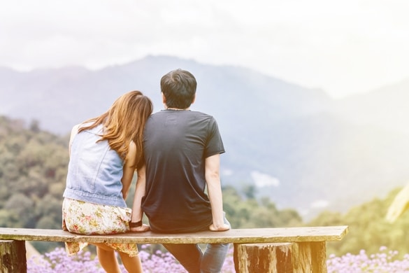 Romantic loving Asia couple sitting on wooden bench - Are Gemini Men Secretive