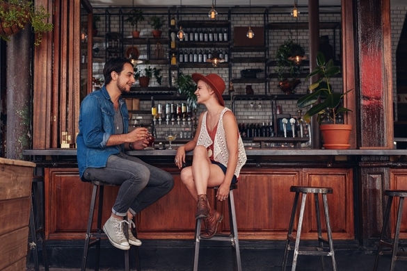 Shot of young couple sitting at cafe counter - What Is It Like To Date A Gemini Man