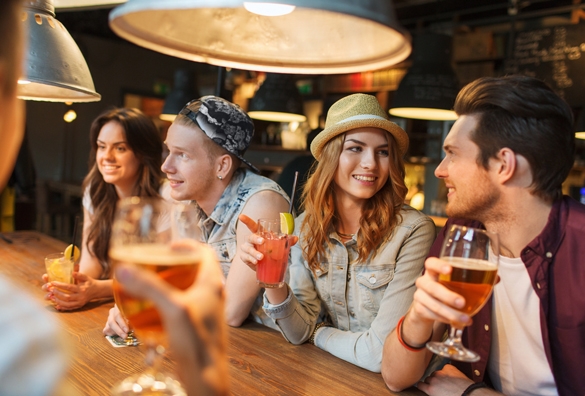 group of happy smiling friends drinking beer and cocktails talking at bar - What Is It Like To Date A Gemini Man